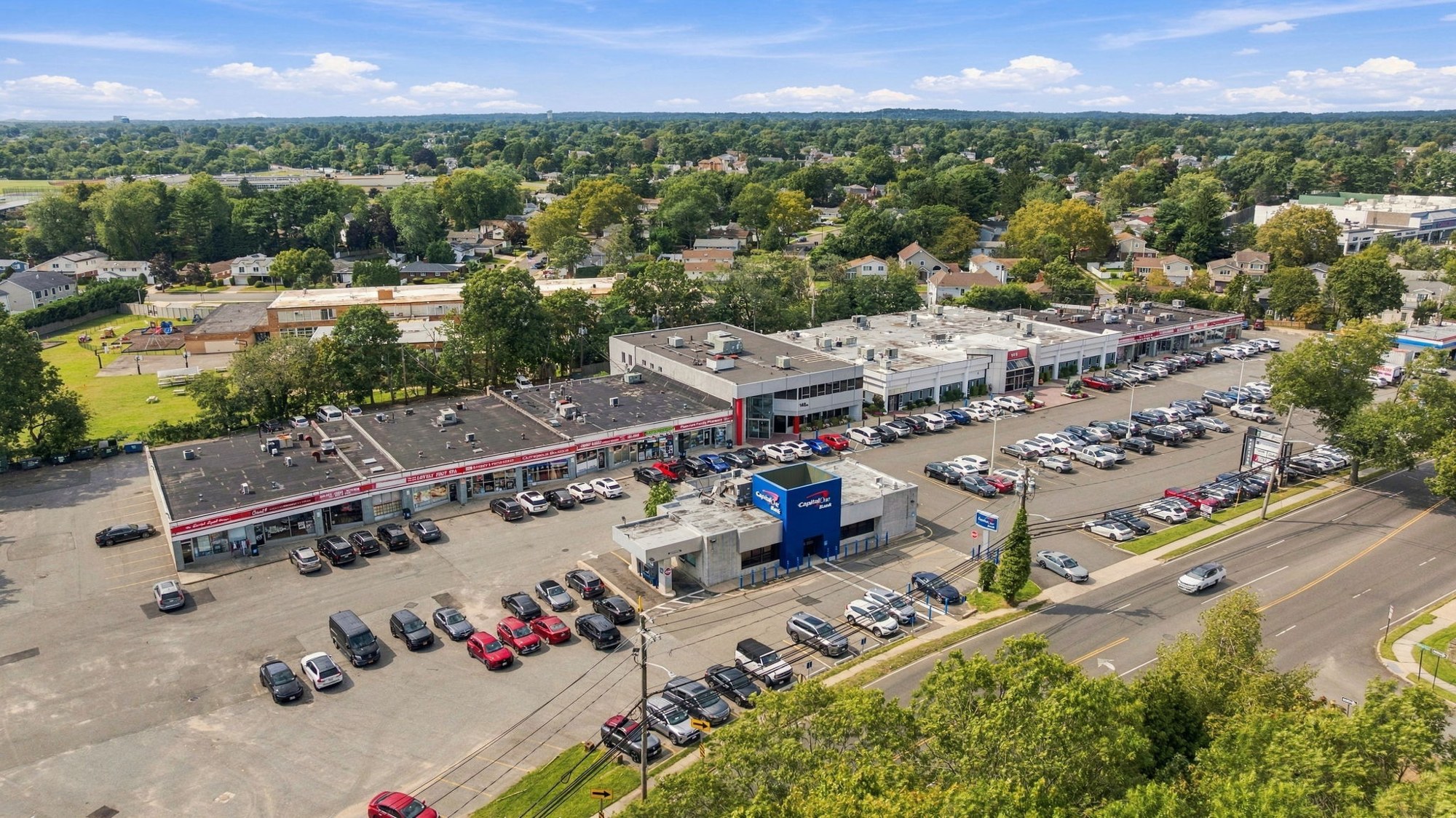 Angled aerial view of the building and its parking field