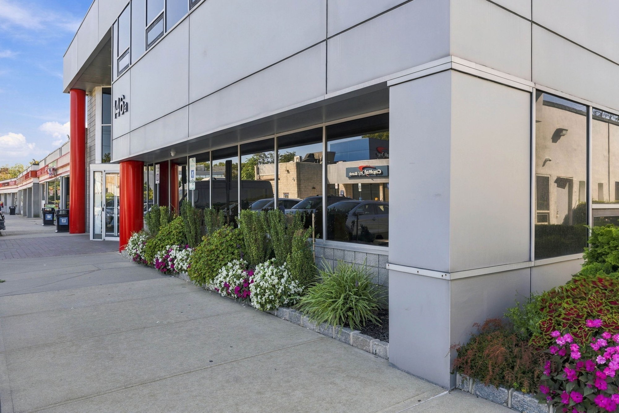 Glass-fronted facade with flowering landscaping at Manetto Hill Road